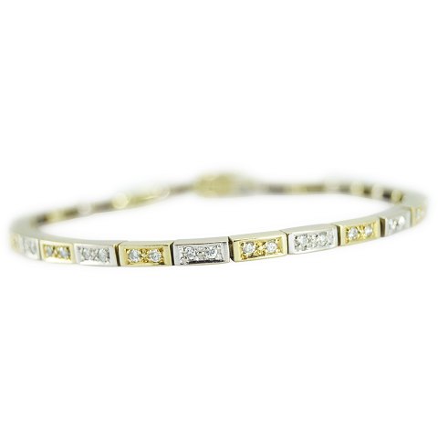 A diamond bracelet mounted in 14k gold and white gold