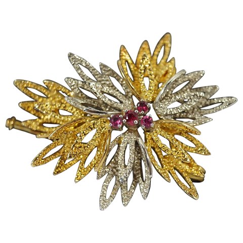 A brooch set with rubies, mounted in 14k gold and white gold