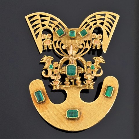 A South-American emerald pendant/brooch mounted in 18k gold, inca inspired