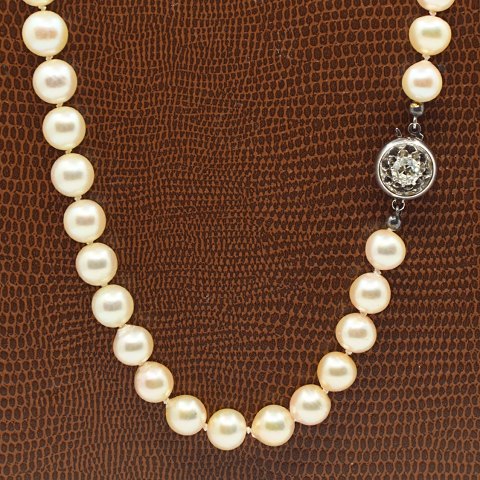 Hugo Grün; A pearl necklace with 14k white gold clasp, set with a diamond