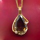 Necklace in 14k gold with pendant of large topaz set with diamonds